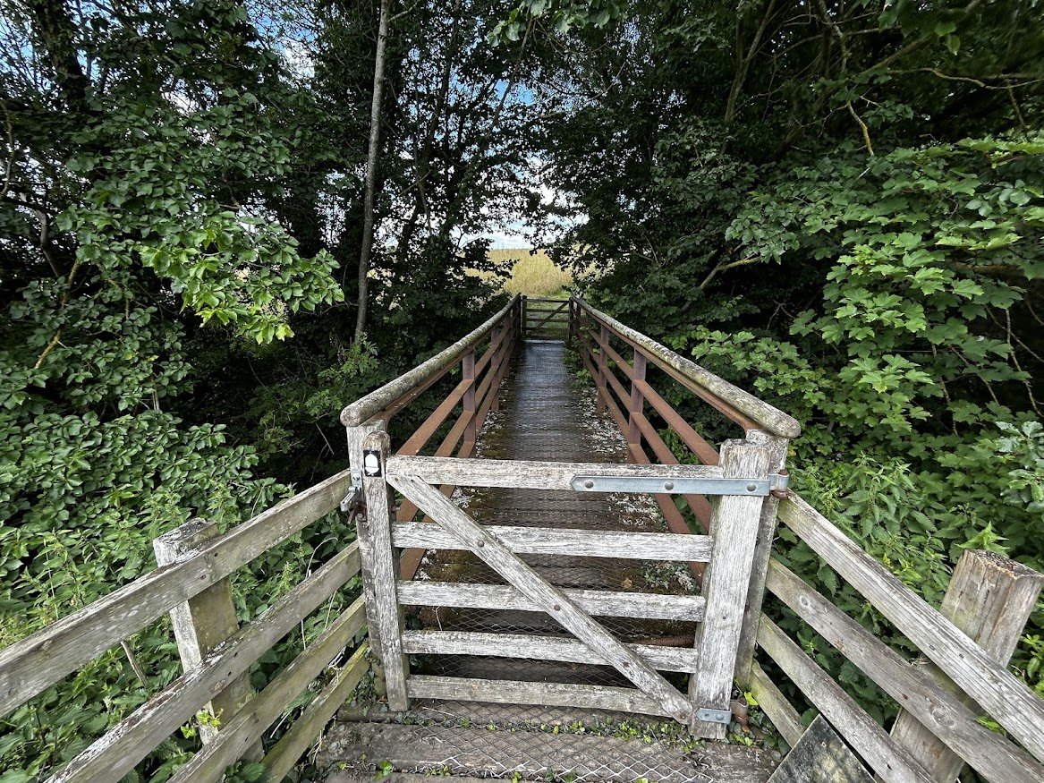 countyside view of gate and bridge woodlands