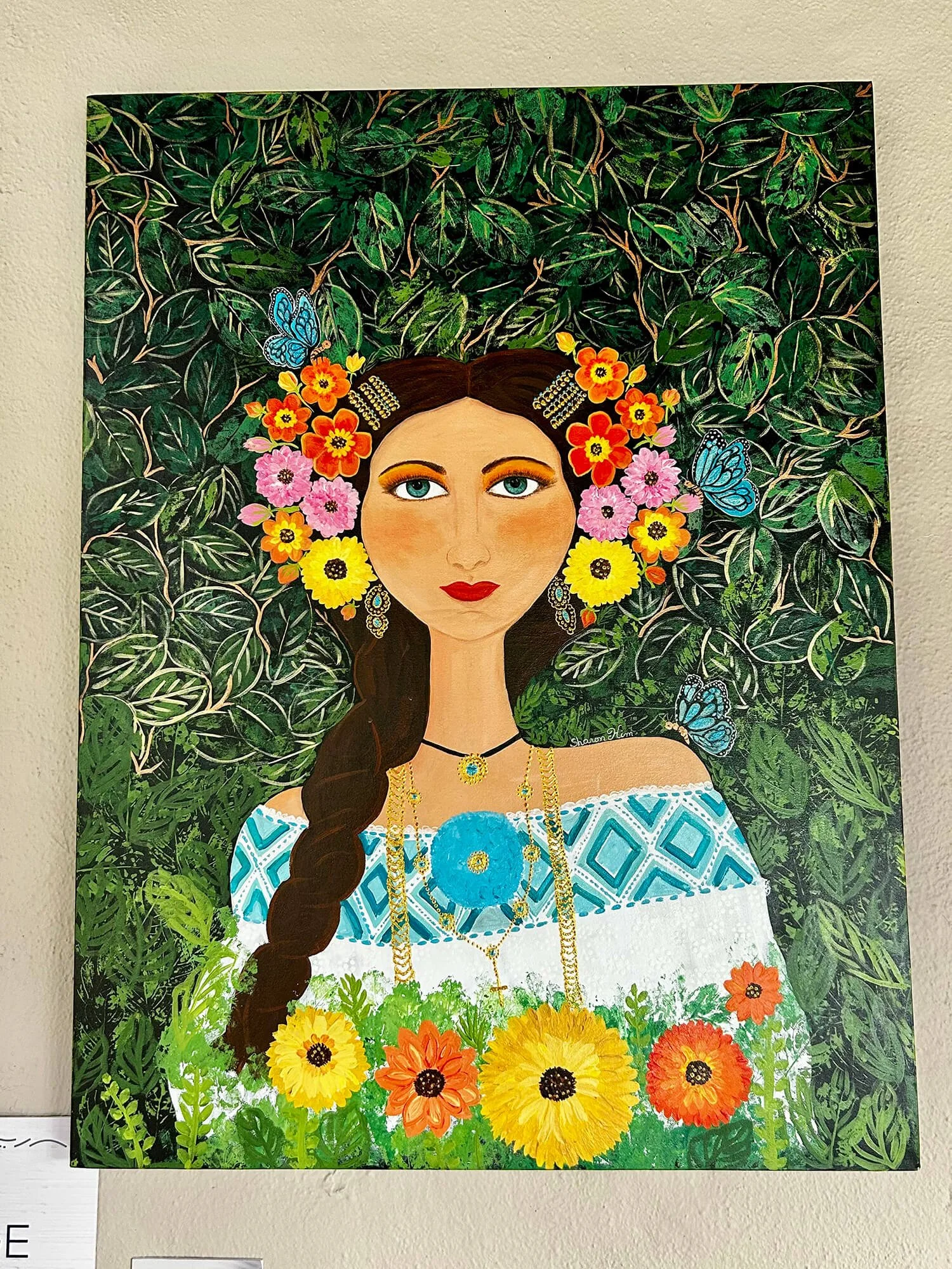 A colorful painting of a woman with long brown hair, adorned with flowers and butterflies, in a lush green garden background.