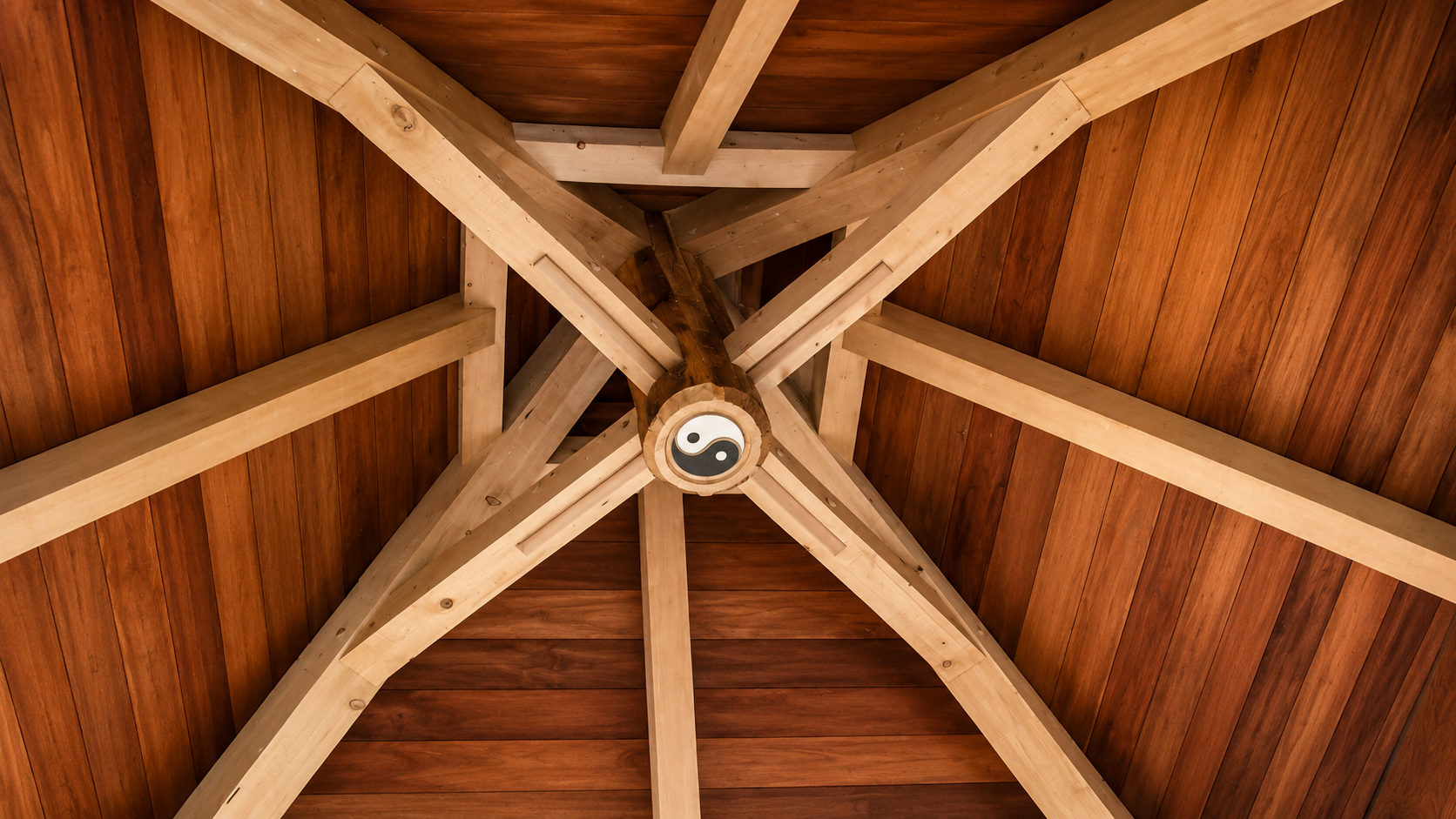 Ceiling with wooden beams and a Yin-Yang symbol at the center.