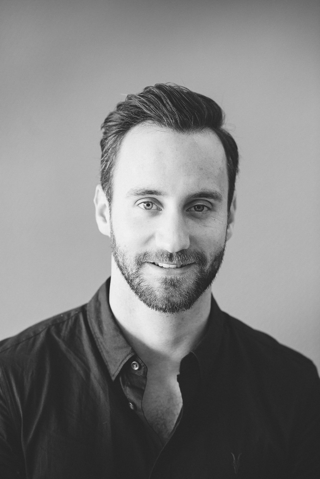 Black and white portrait-style business headshot.