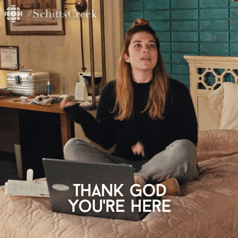 gif of Alexis Rose from Schitts Creek saying, "thank god you're here because I have so many questions".  She's wearing PJ's sitting on a bed in a cheap motel.