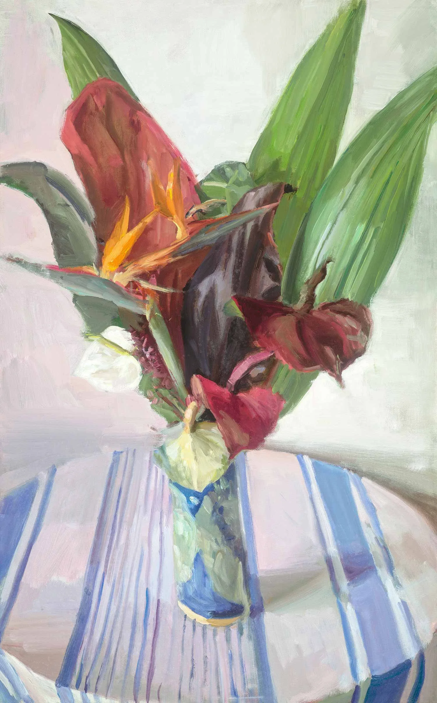 A painting of a tropical bouquet of flowers in a blue vase on a table with a striped tablecloth.