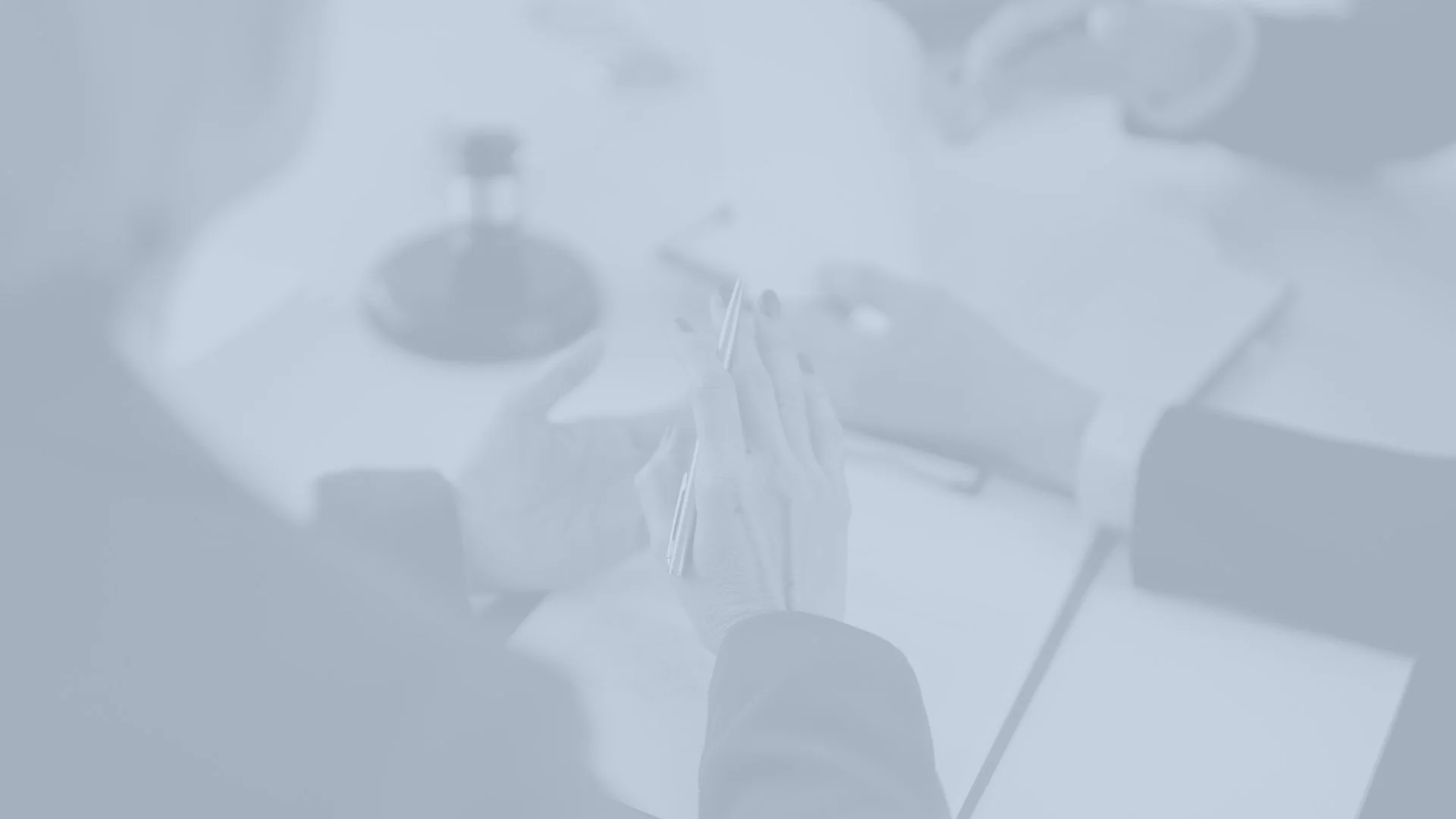 A person preparing a syringe with medical gloves, a stethoscope, and a vial on the table.