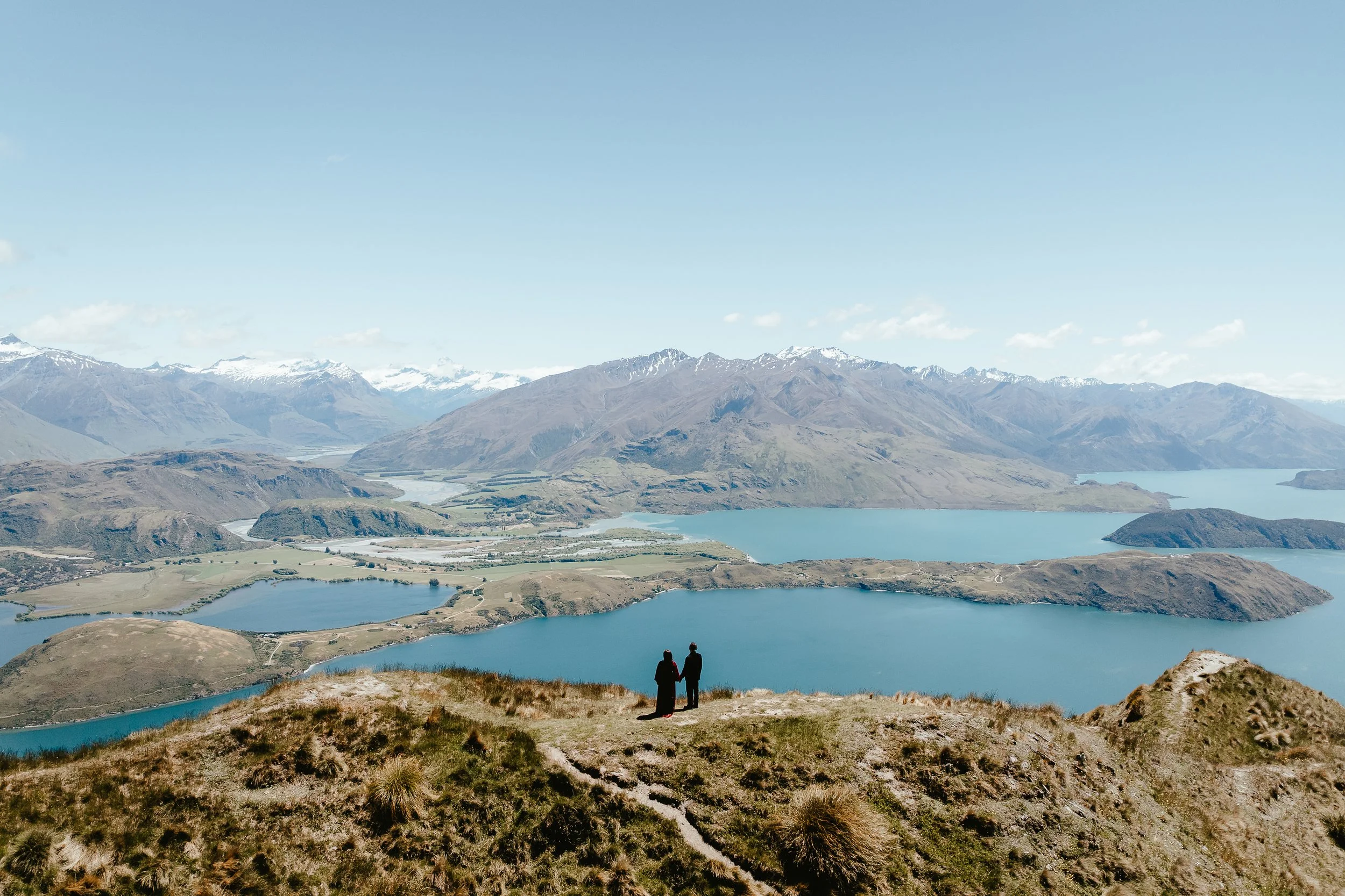 Couple holding hands on Coromandel Peak during their heli elopement