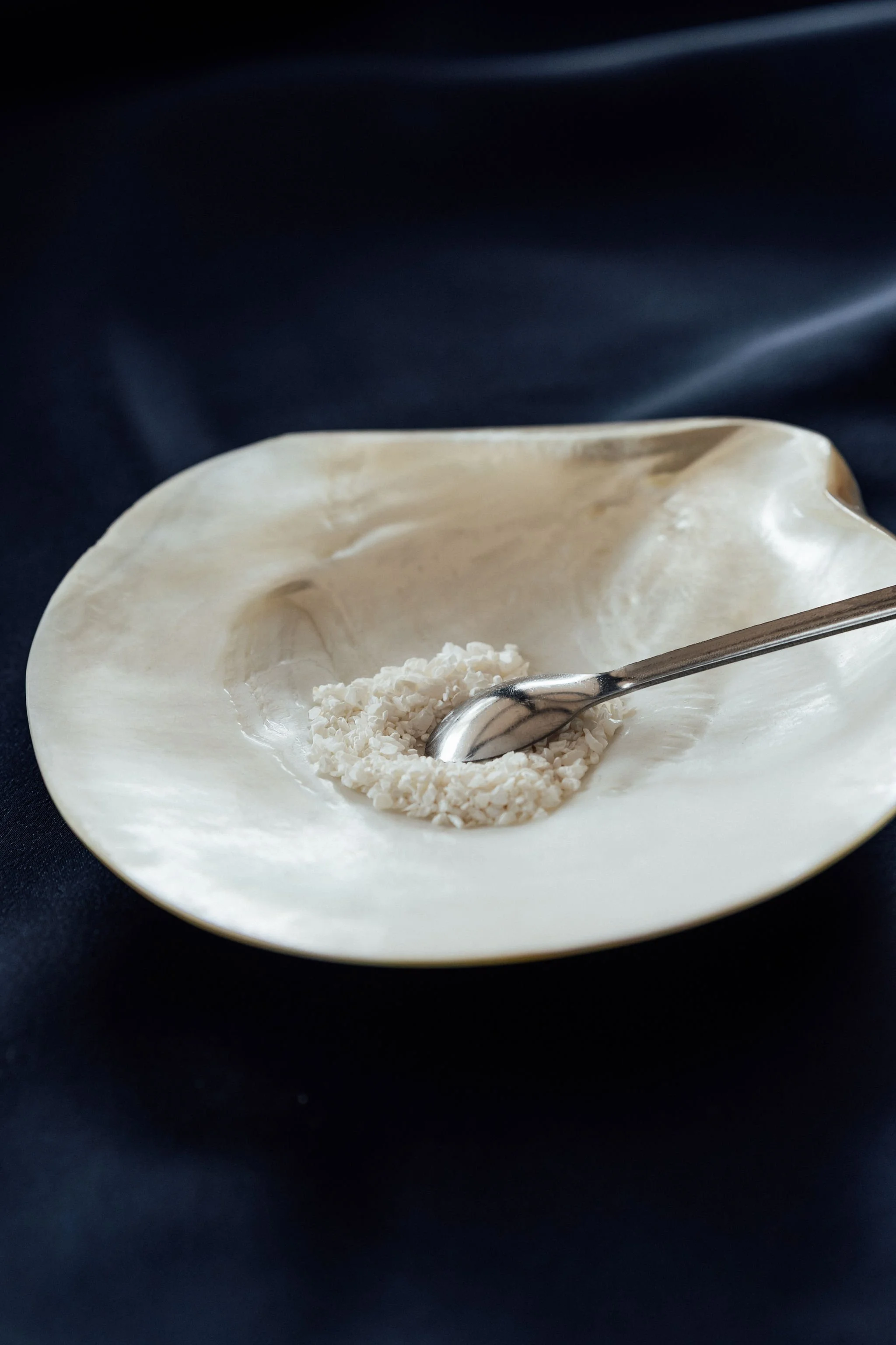 Laboratory technician handling PearlBone™ biomaterial using a surgical spatula