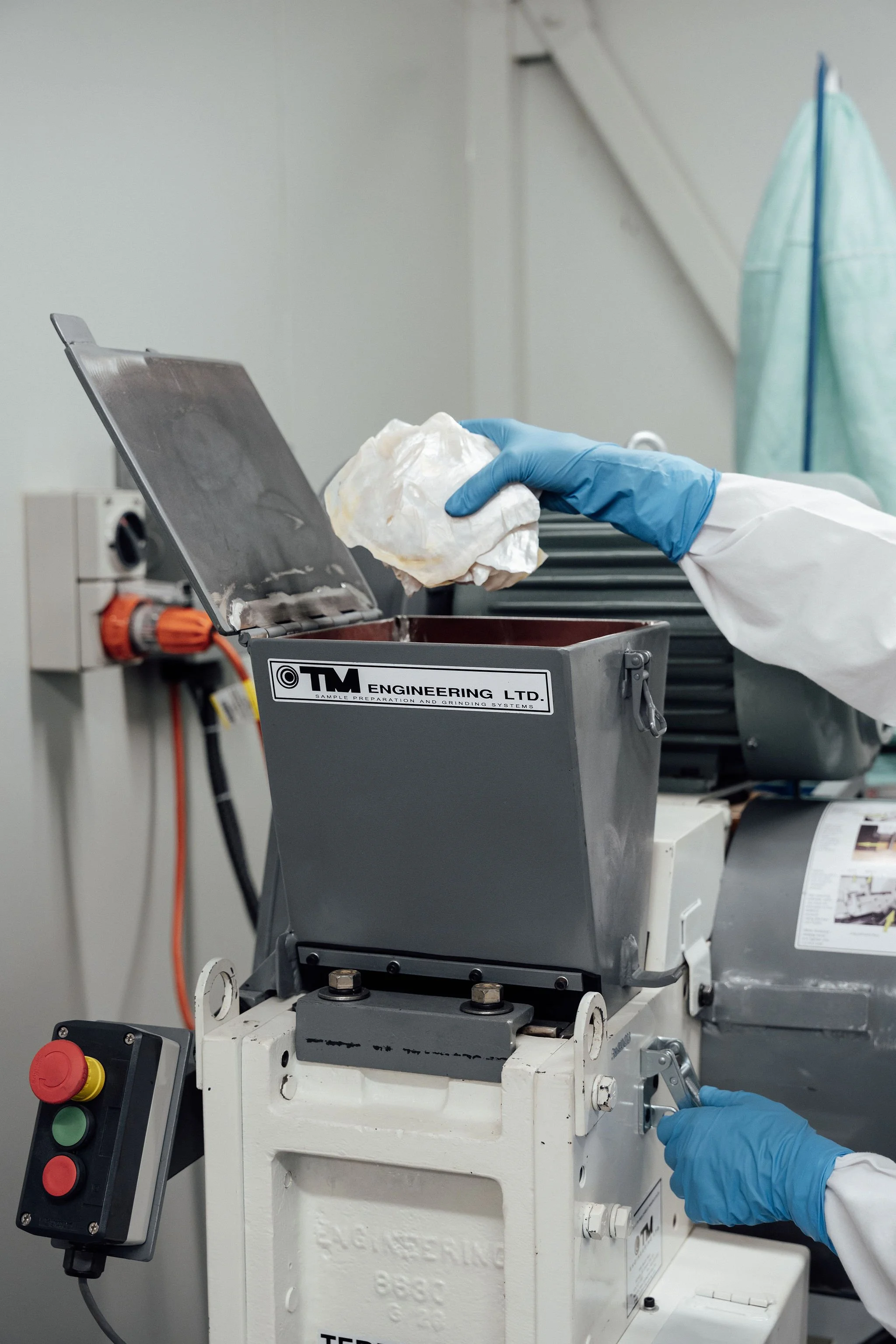 Laboratory technician handling biomaterial powder using controlled equipment