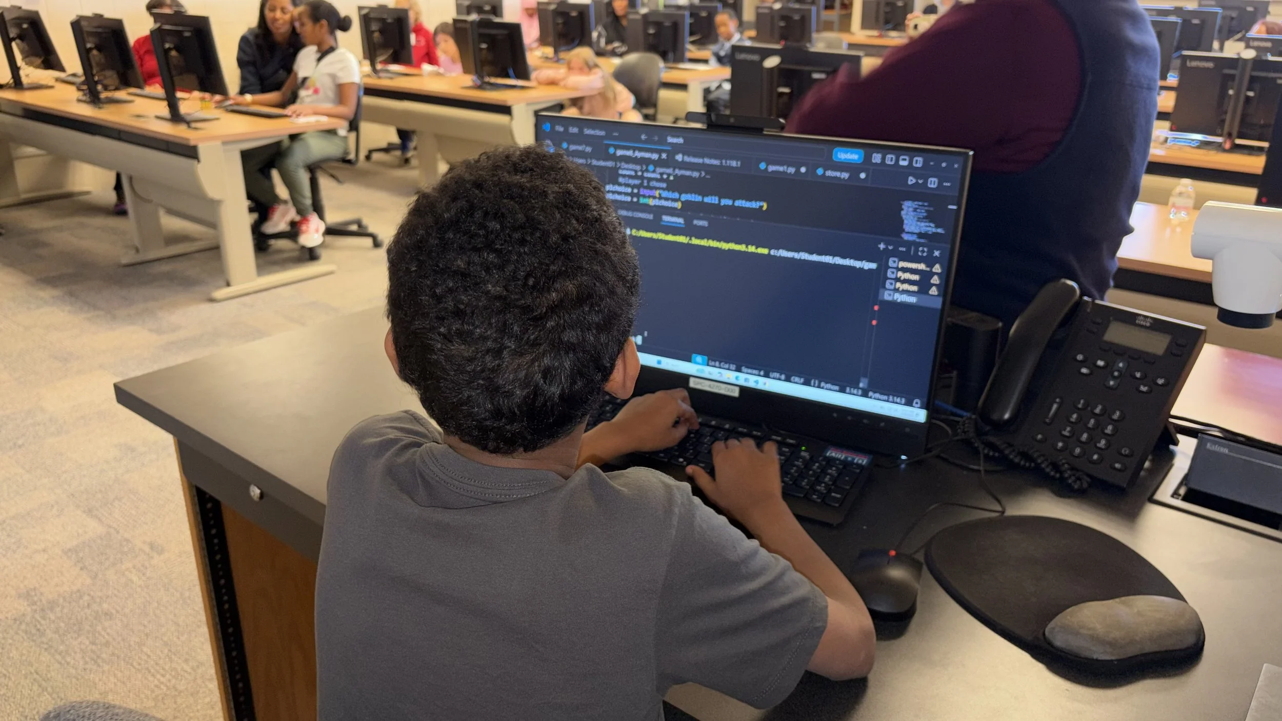 python coding student giving a presentation at a computer