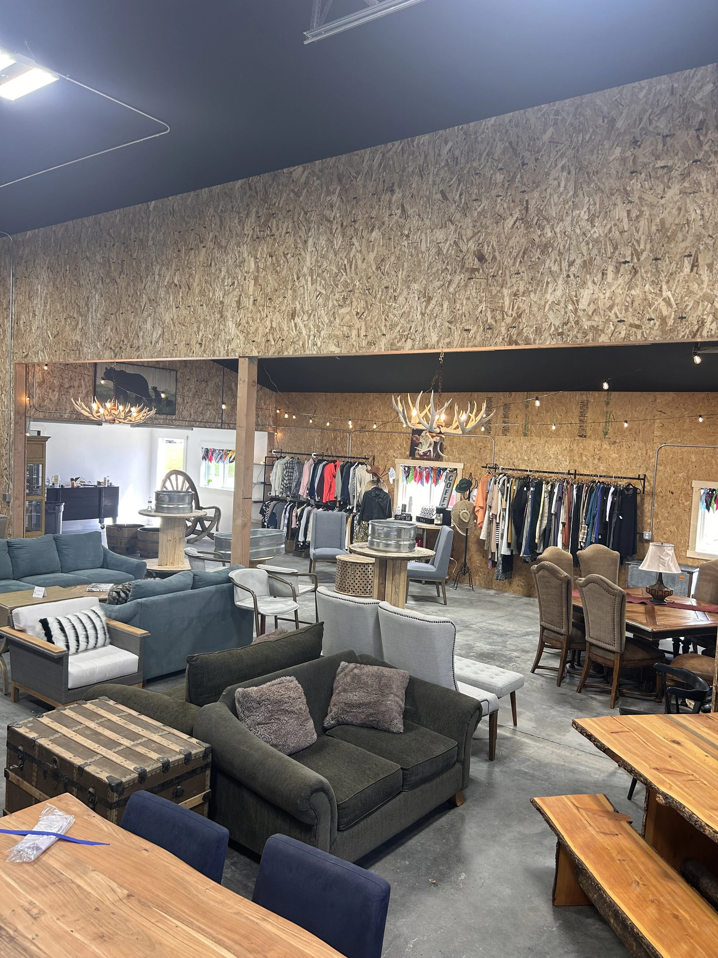Up high view of the ReStore ReServe showcasing furniture on the floor for sale while clothing is hung on the far wall.