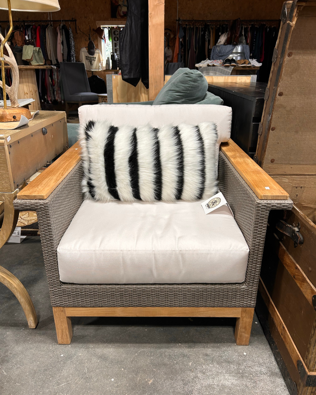 White, gray, and medium tone wood chair for sale at the ReStore ReServe with a black and white striped, fur throw pillow.