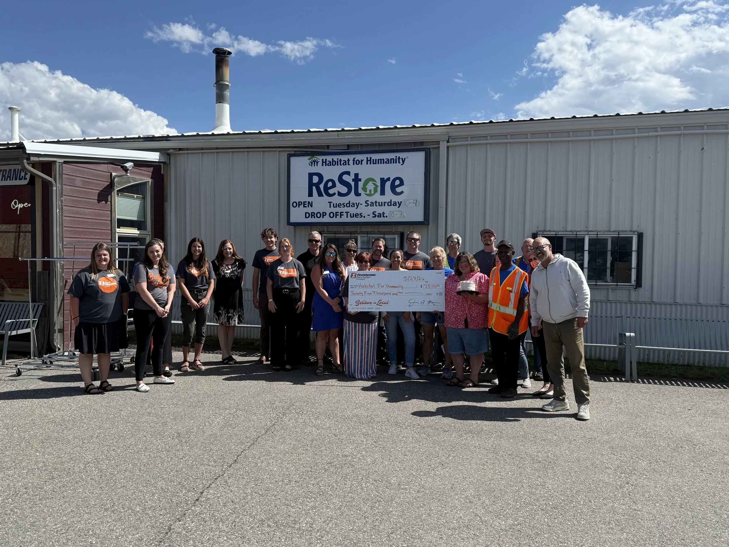 First Interstate BankGand HHV employees standing in front of the ReStore holding a check awarded to HHGV..