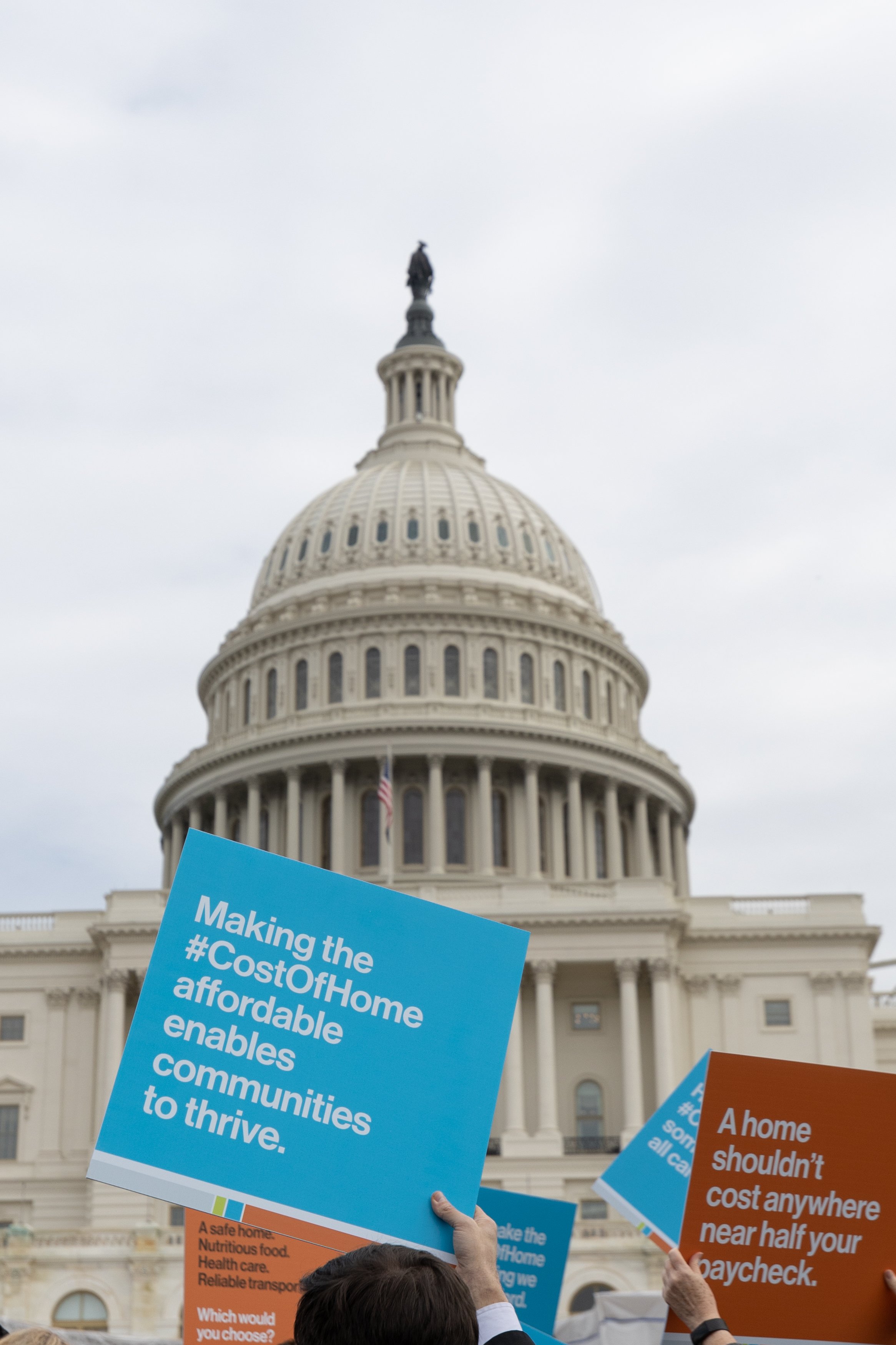 Protesters holding signs in front of the United States Capitol building.