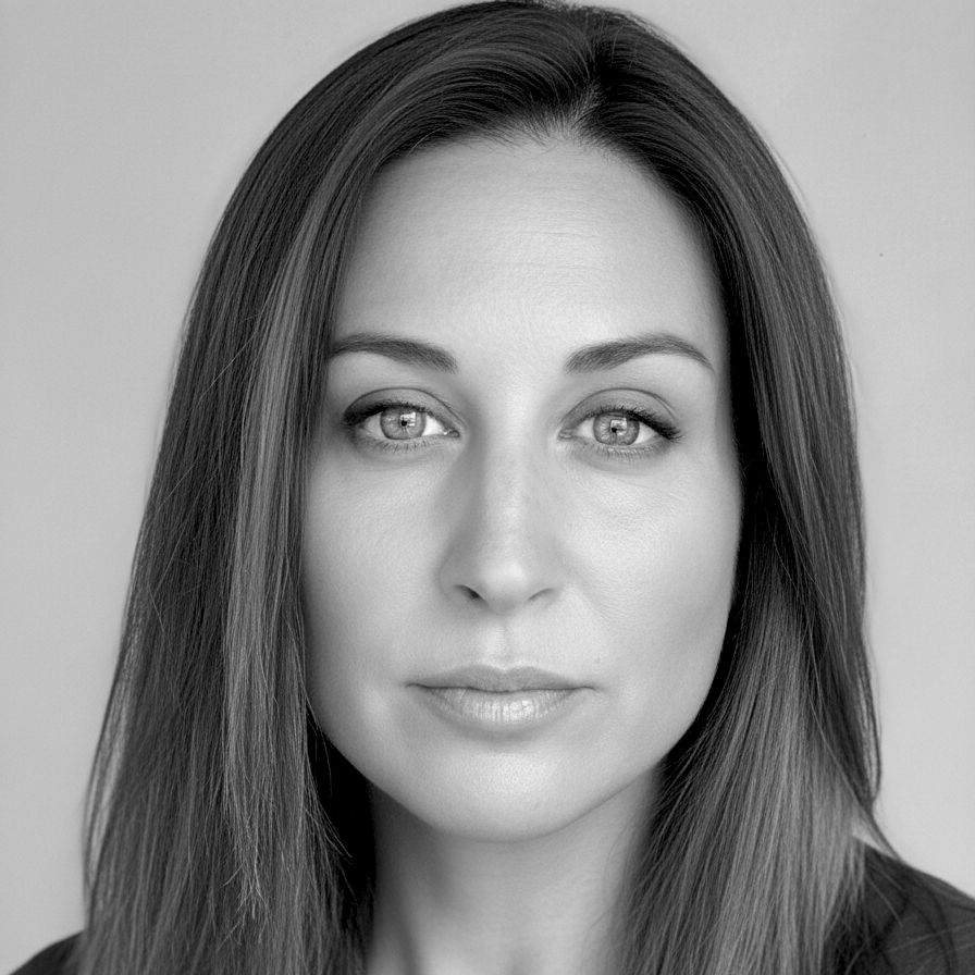 Black and white portrait of a woman with straight hair and light eyes, looking directly at the camera.