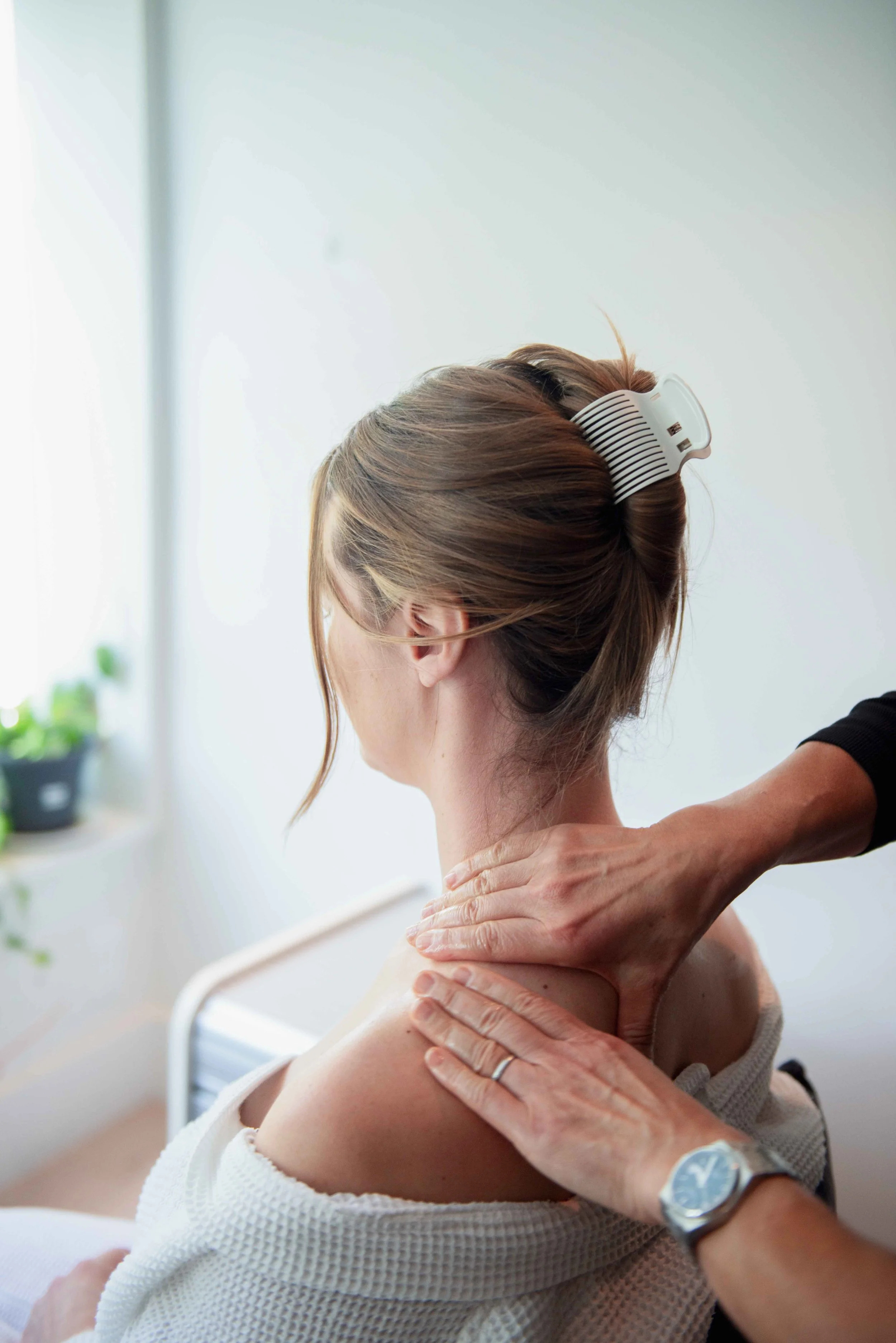 A woman receiving neck and shoulder massage.
