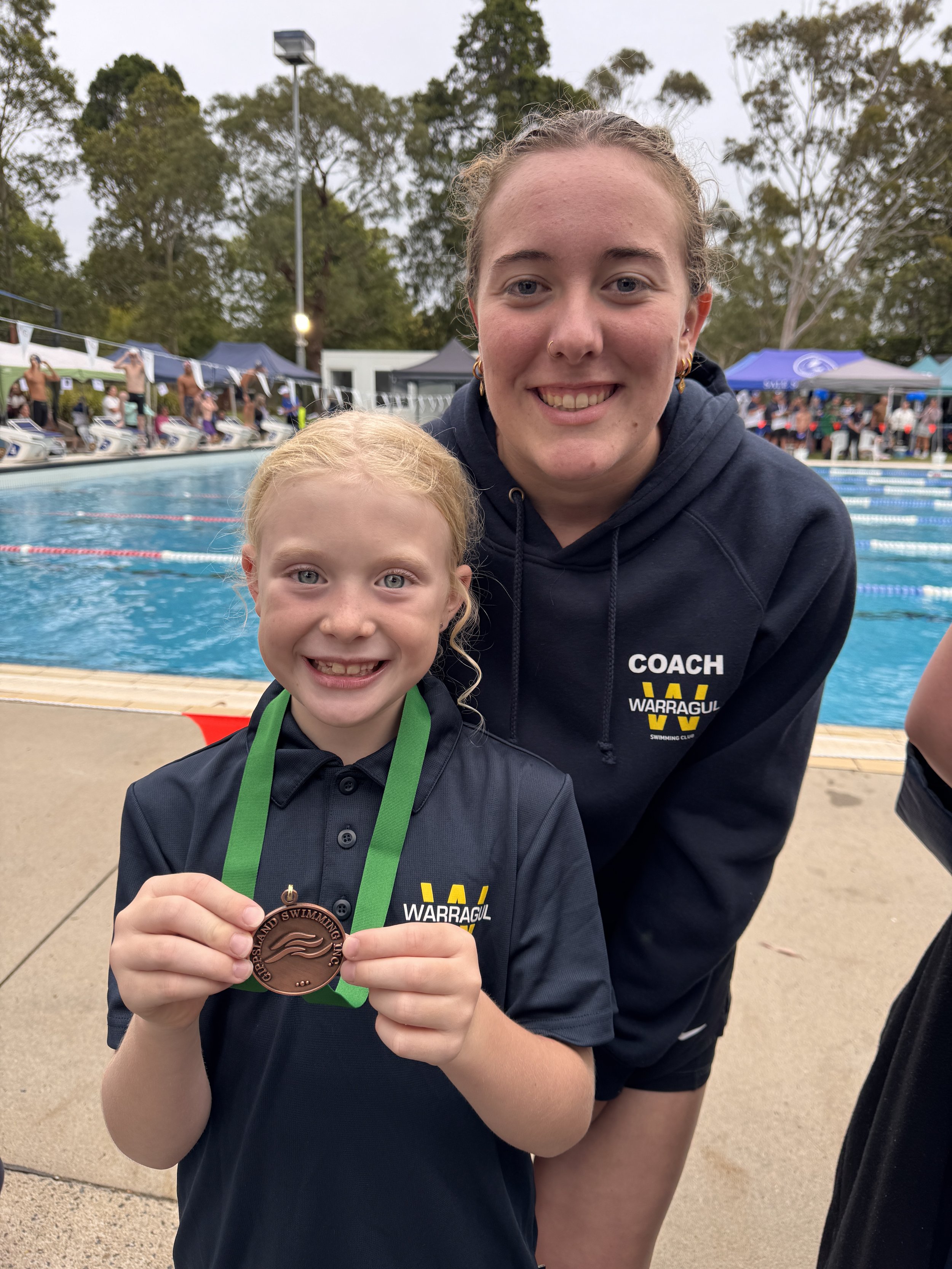 A Warragul Swimming Club junior squad swimmer with coach
