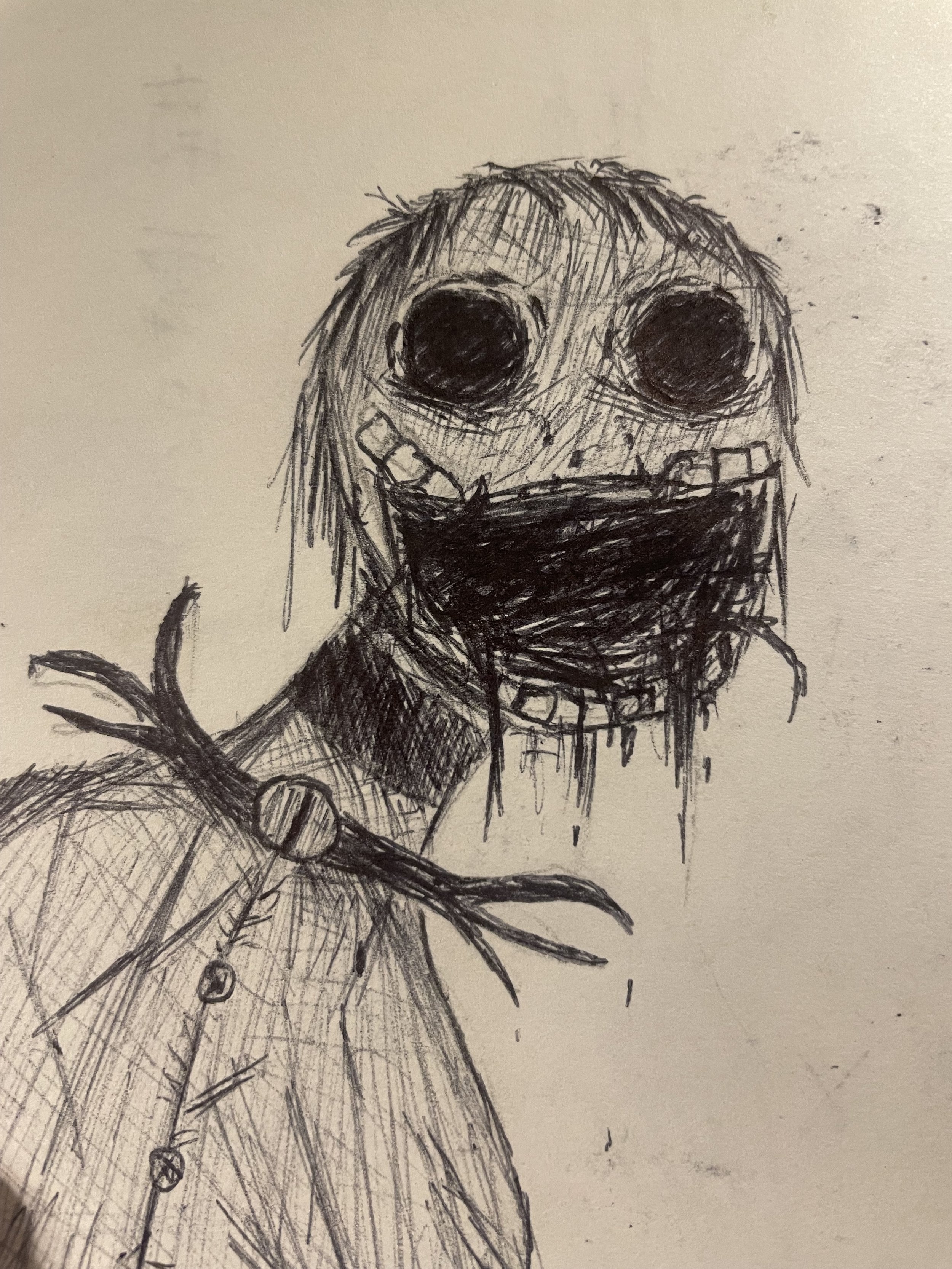 A dark, creepy sketch of a face with large black eyes and a wide, open mouth with uneven teeth. The face is attached to a figure wearing a jacket with buttons and a collar, holding a stick or stick-like object. The drawing has a rough, sketchy style.