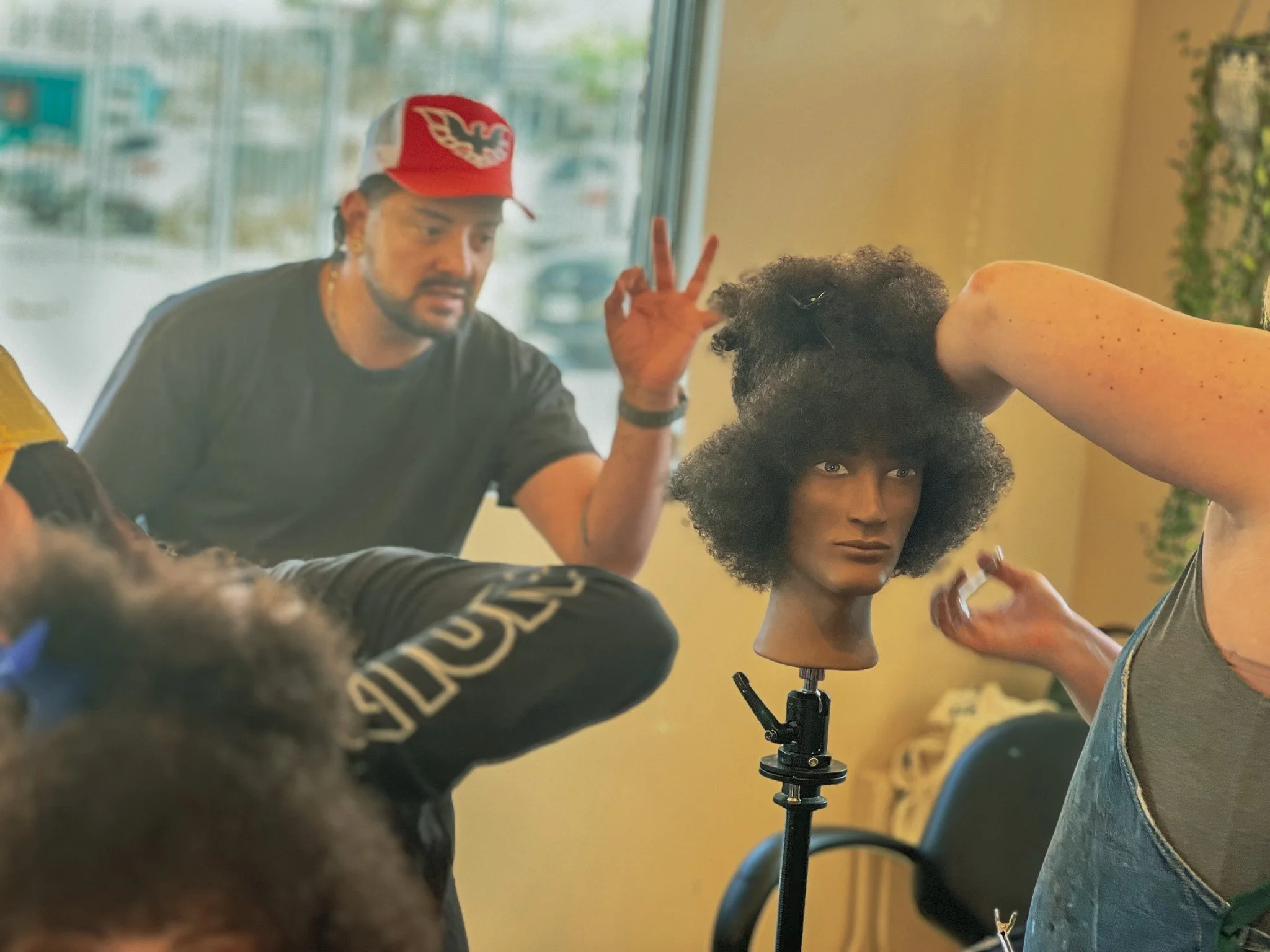 Ron Lopez gives an artist the okay sign during class.