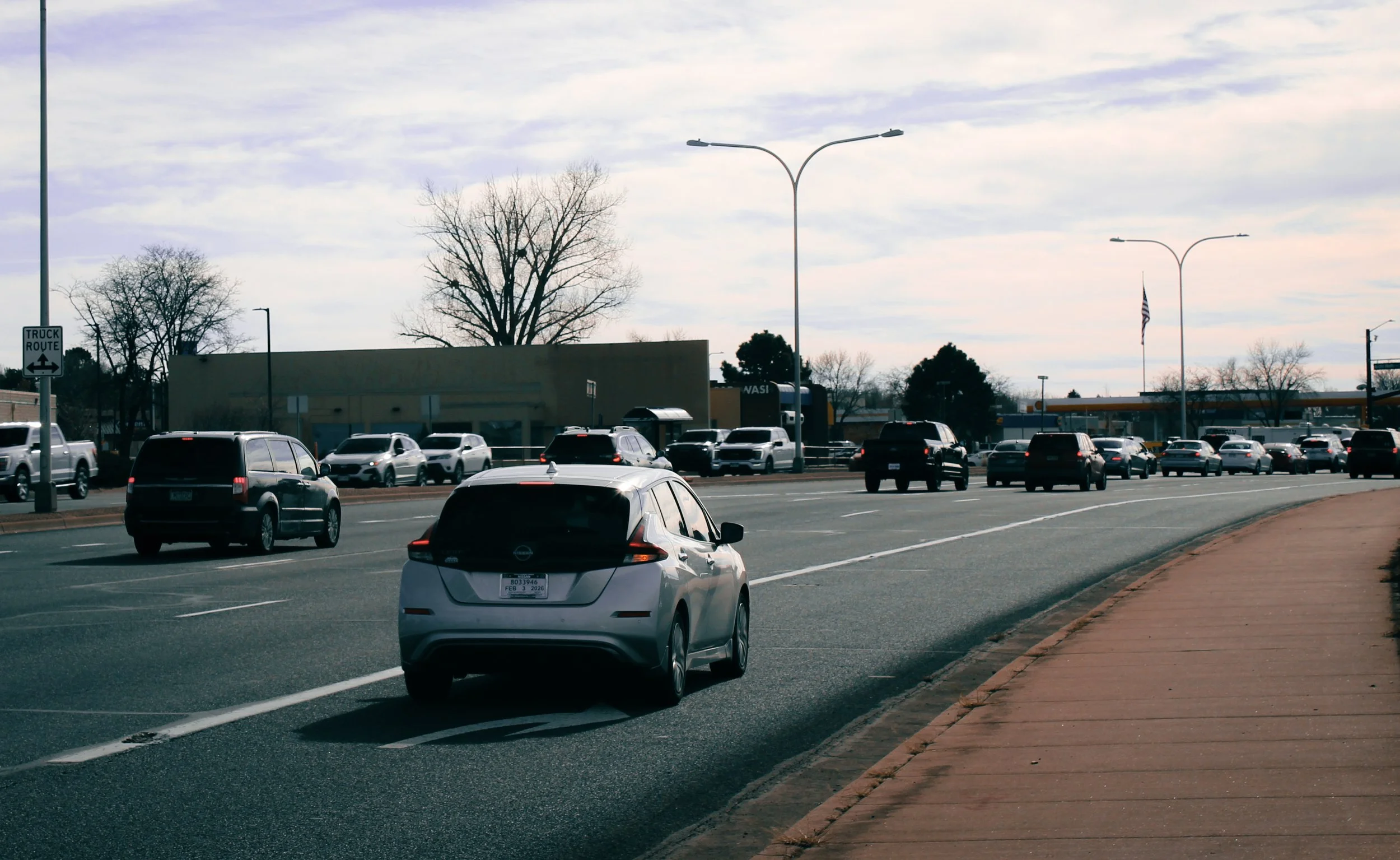 Cars driving toward an intersection all braking and clustering.