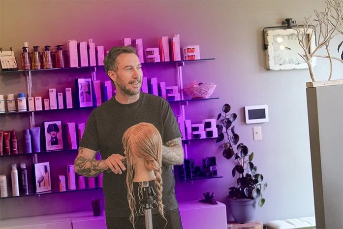 Aran Beattie combs through a mannequin as he teaches at Starling Salon,