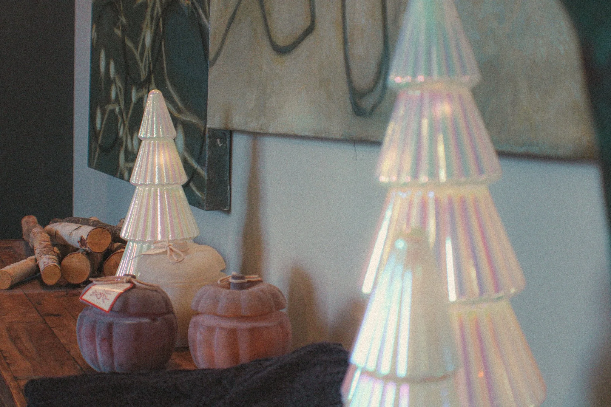 Two glass christmas tree decorations sit on a dresser in the salon.