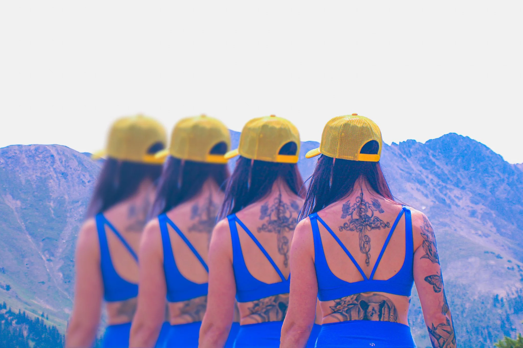 A quadruple image of Kate, back to the camera as she views the distant mountain range.