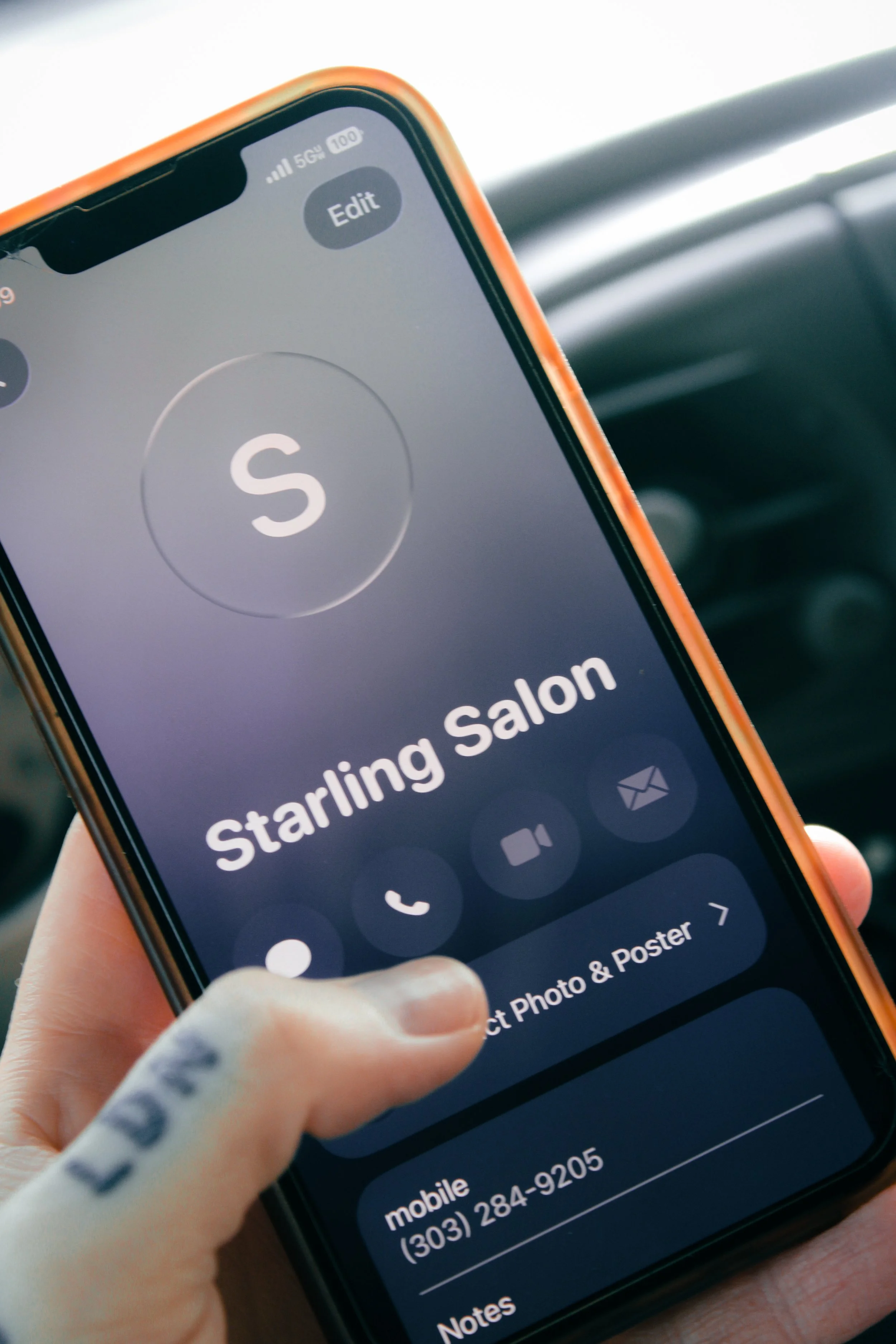 A closeup of a phone screen calling Starling Salon.