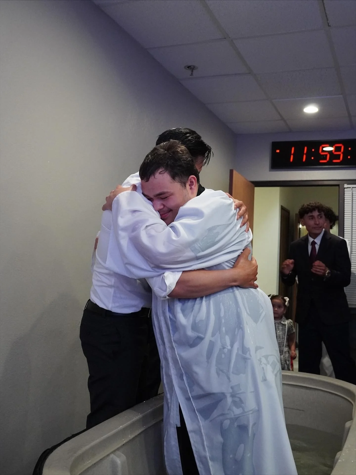 Church members hugging and encouraging each other at Strong Tower Pentecostal Church in Santa Maria