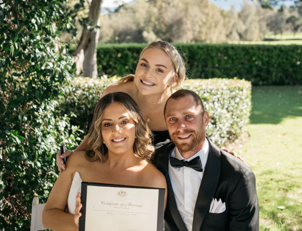 Loved by Chelsea celebrant Chelsea Lawler smiling with a newly married couple at The Grange wedding venue, capturing a joyful moment during their personalised wedding ceremony.
