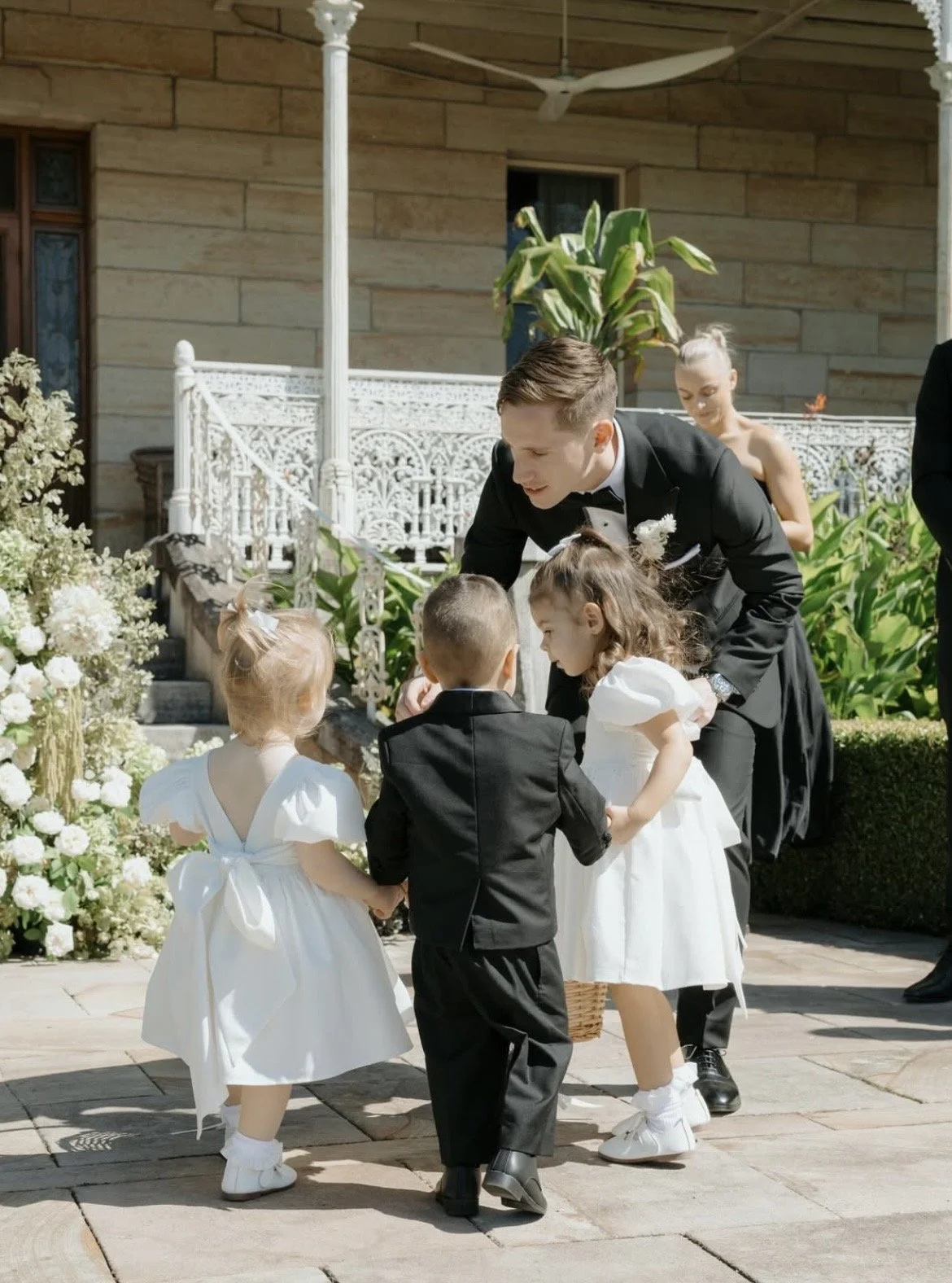 Couple with their young children during their wedding ceremony at Terrara House, with celebrant Chelsea officiating.