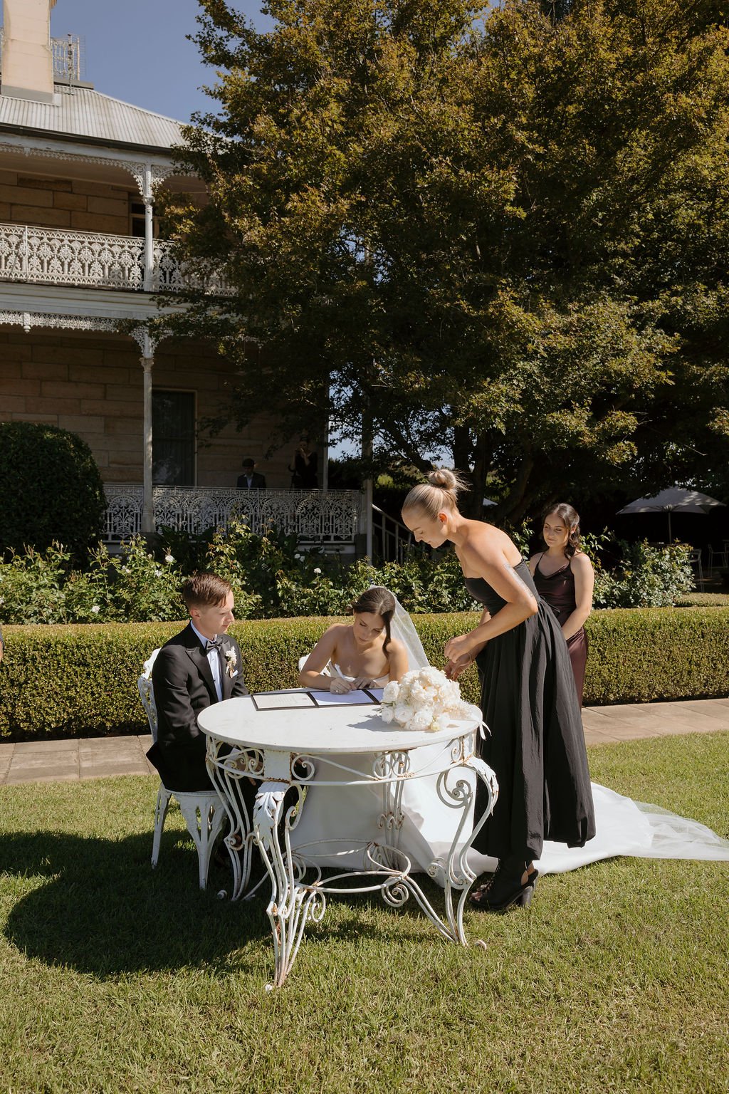 Loved by Chelsea celebrant Chelsea Lawler signing marriage documents with a newly married couple at Terrara House Estate, capturing the intimate legal moment of their wedding ceremony surrounded by timeless country elegance.