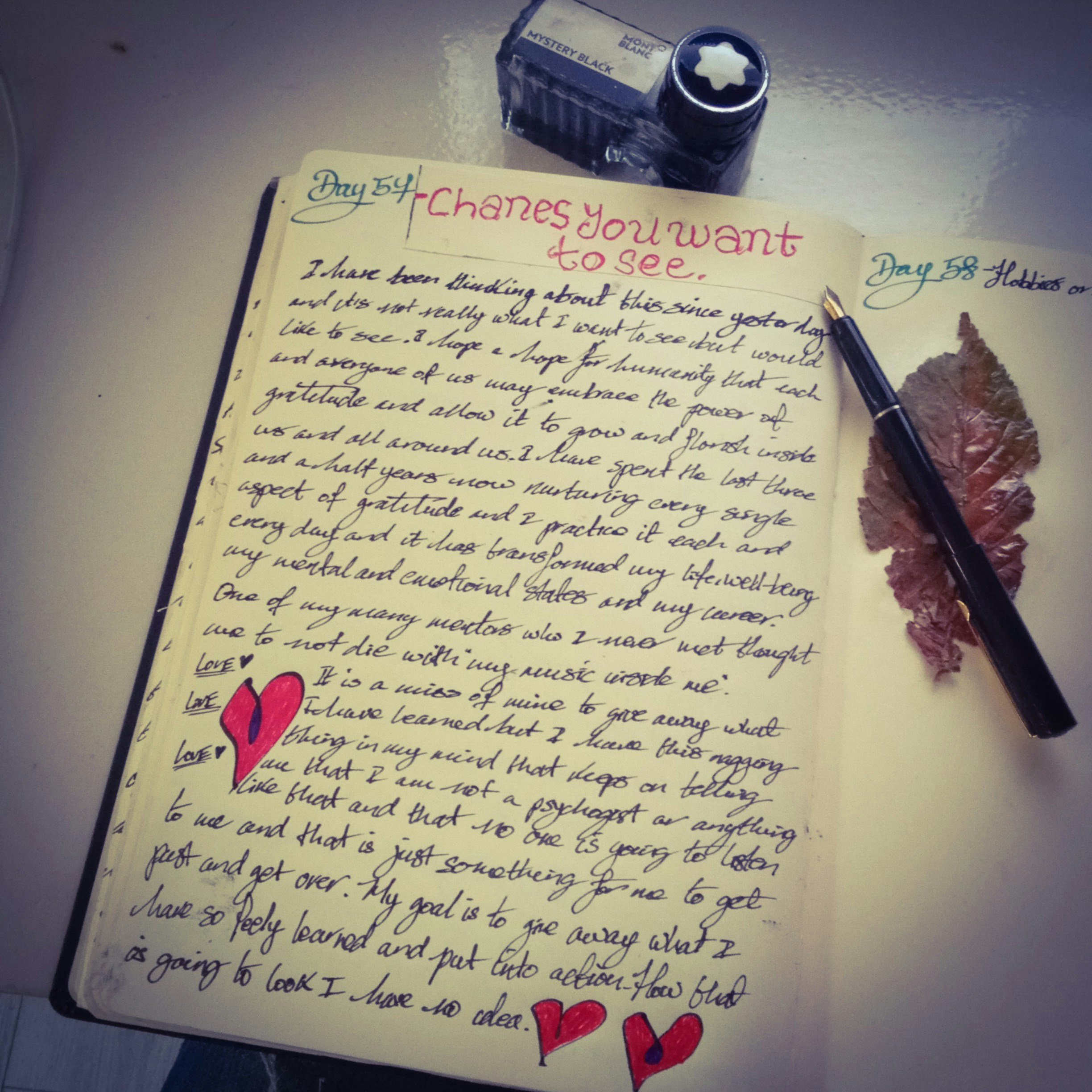 Open journal with handwritten notes and a pen resting beside it, symbolizing reflection, journaling, and self-compassion exercises.