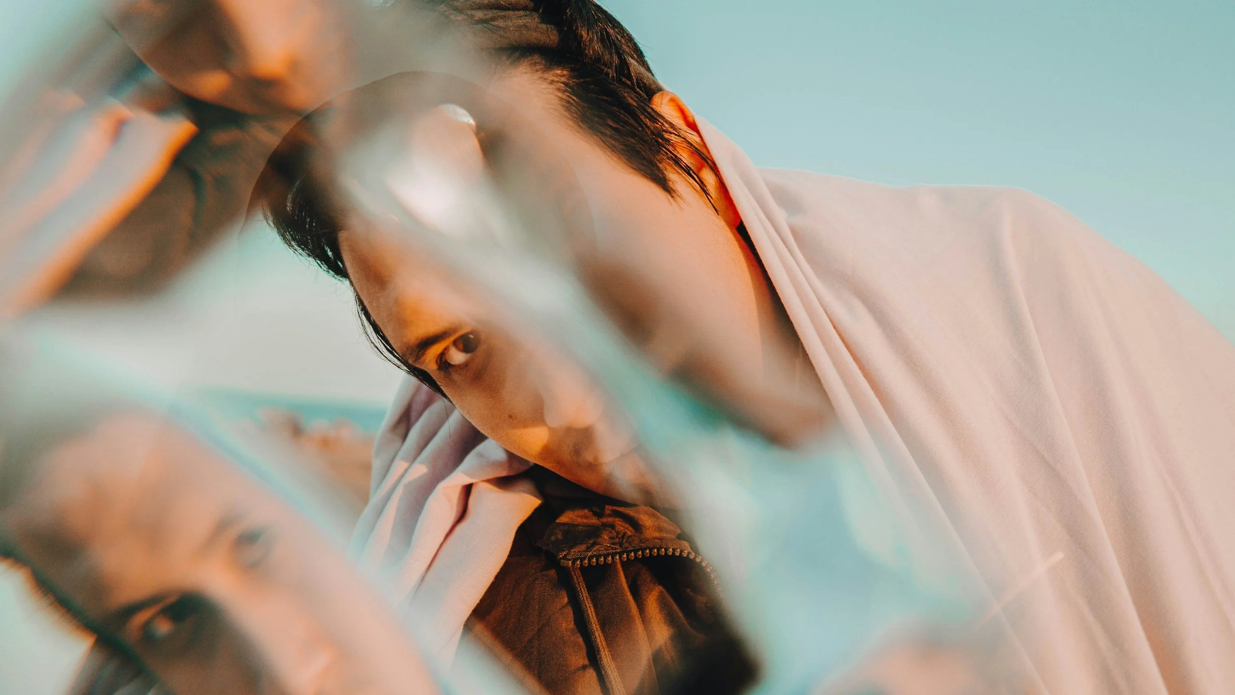 Person looking through distorted reflection symbolizing emotional instability and identity confusion in borderline personality disorder