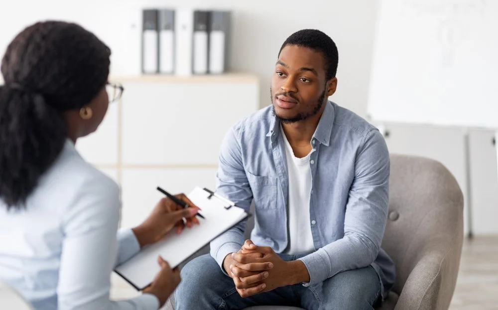 Therapist speaking with client during counseling session, representing support and healing from narcissistic relationship experiences