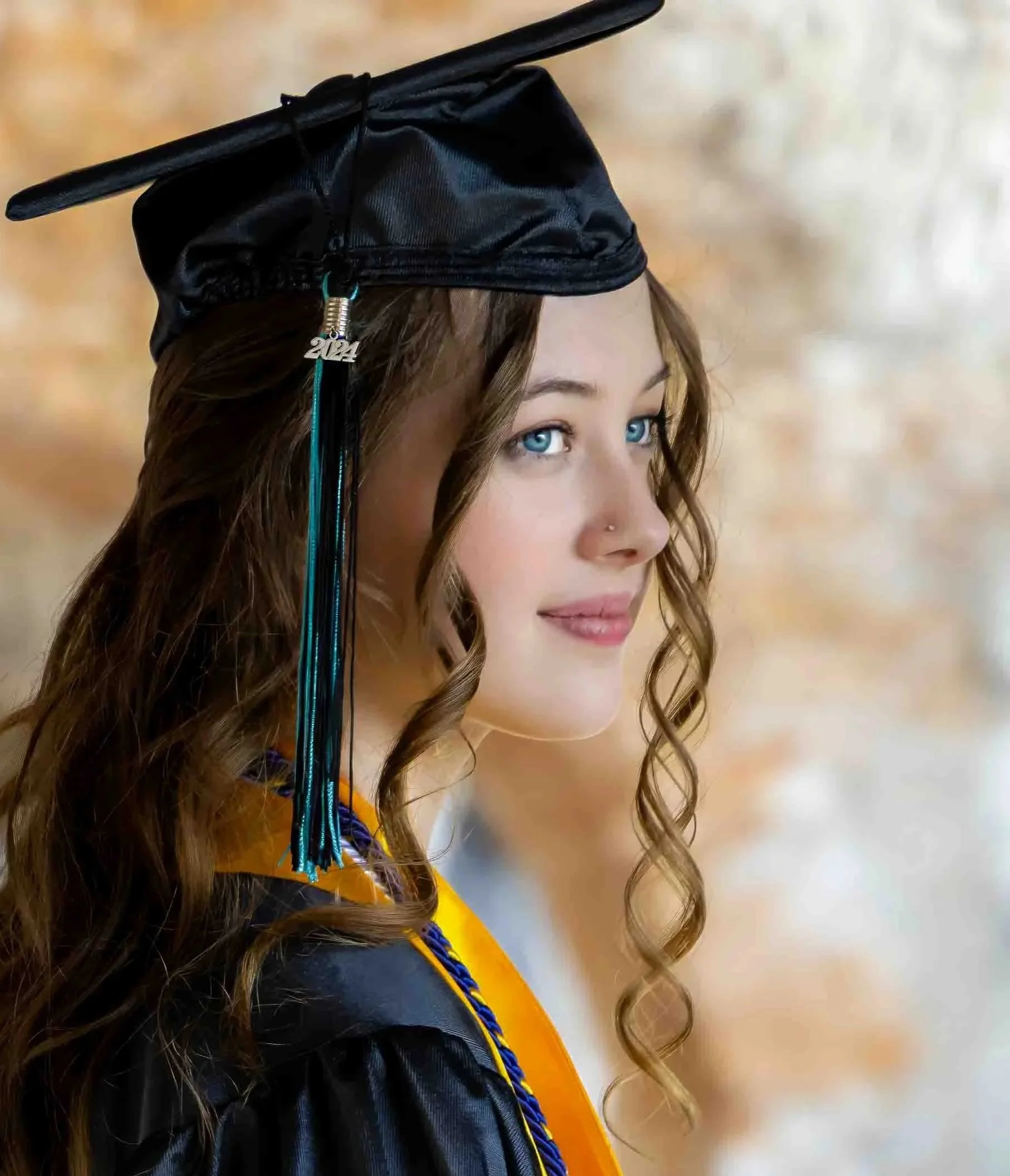 Close up of a beautiful graduating senior girl in cap and gown