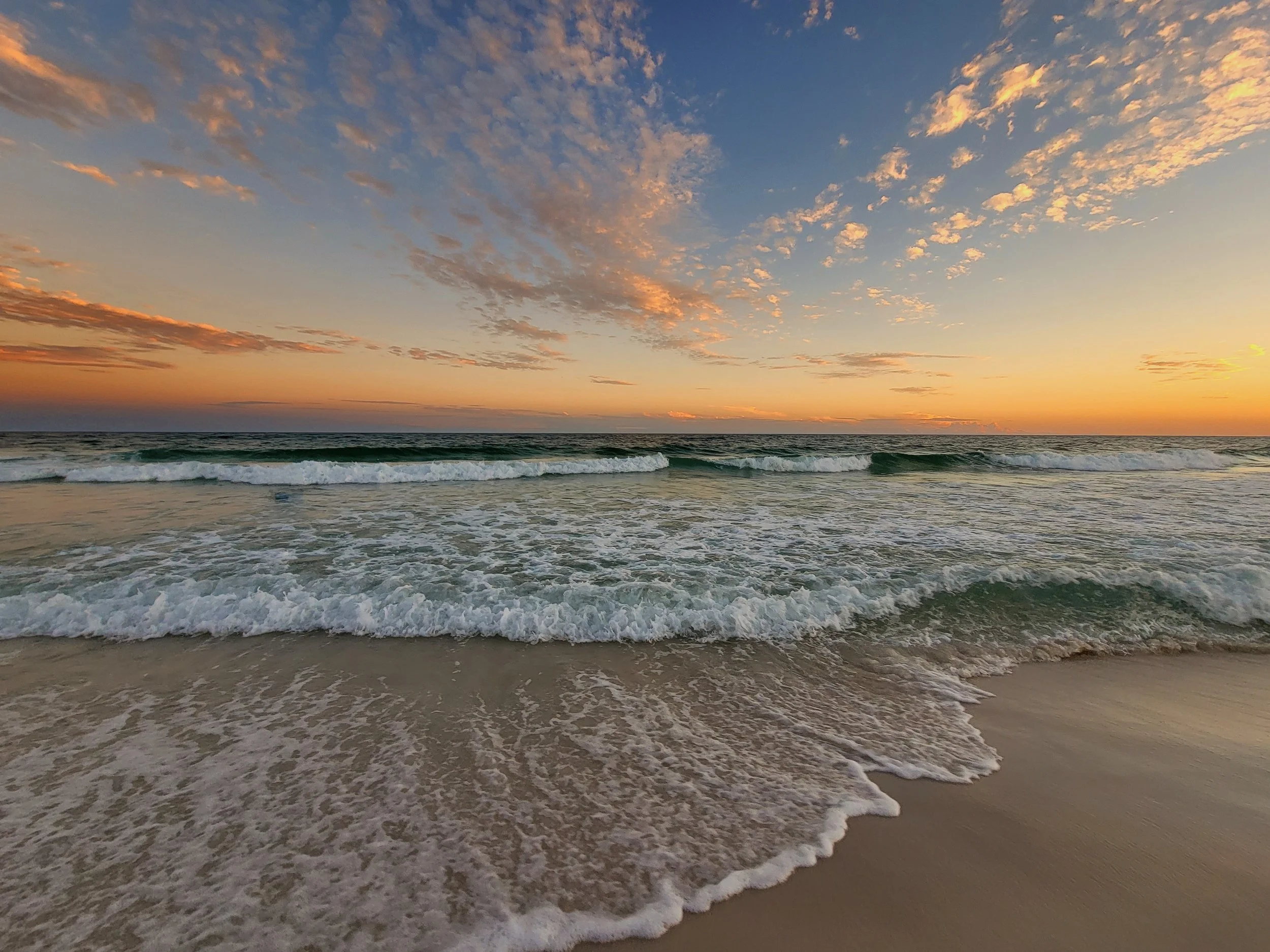 Golden hour sunset portrait  on Pensacola Beach as the tide rolls in