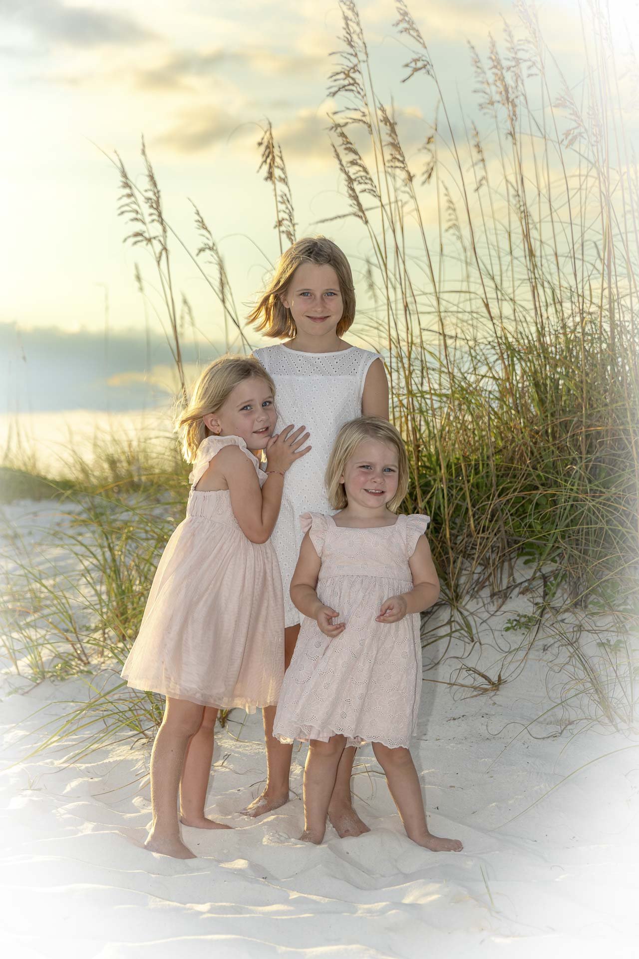 Three sisters walking on Pensacola Beach during golden hour family portrait session