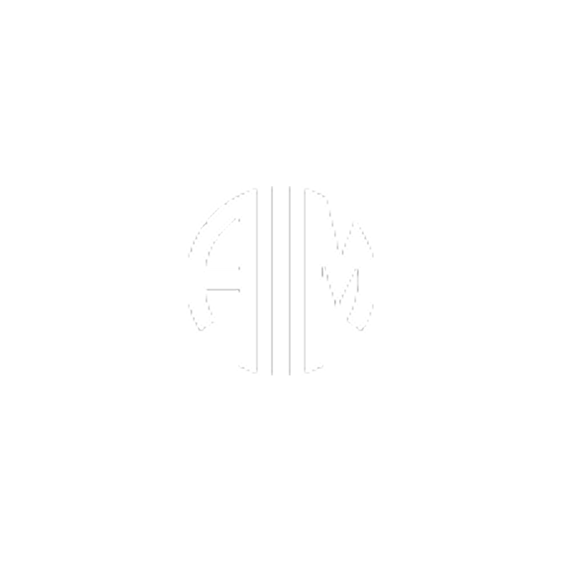 A modern house with a large glass window, situated in a mountainous landscape with dry grass and a few small trees.