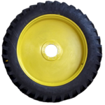 Close-up of a yellow tractor wheel with a blue hubcap