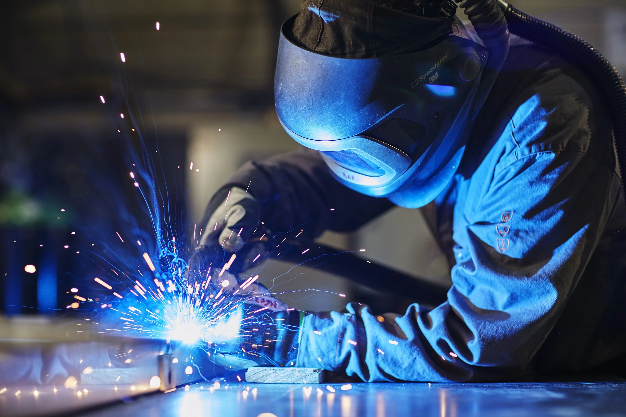 A person welding in safety clothes