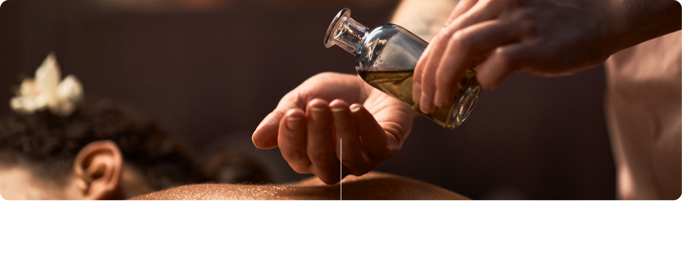 A person is pouring oil onto a person's back during a massage or spa treatment.