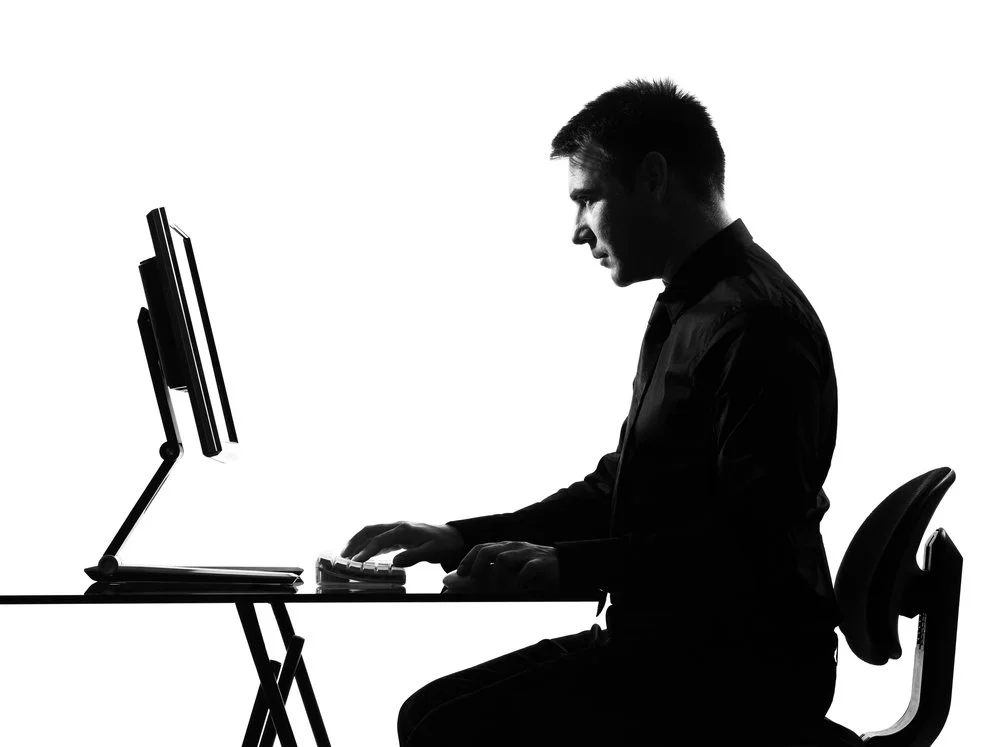 man at desk in silhouette author fatherhood pensive memoir