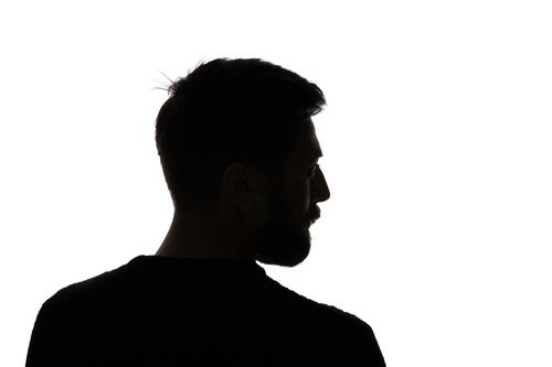 Silhouette of a man with a beard and short hair in profile view, facing to the right against a white background.