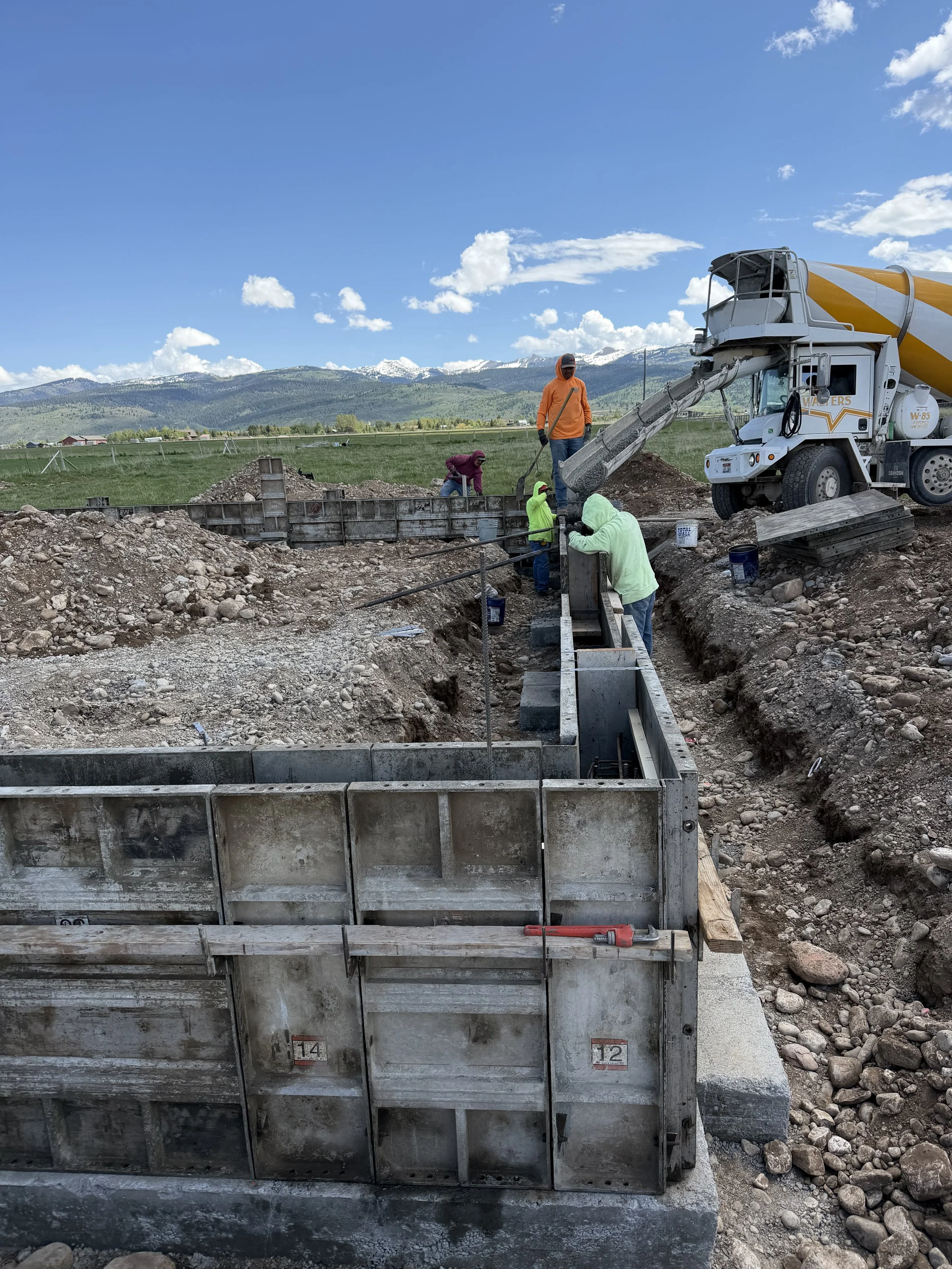 Excavation and concrete foundation work for a 50-by-50 steel shop in Victor, Idaho.