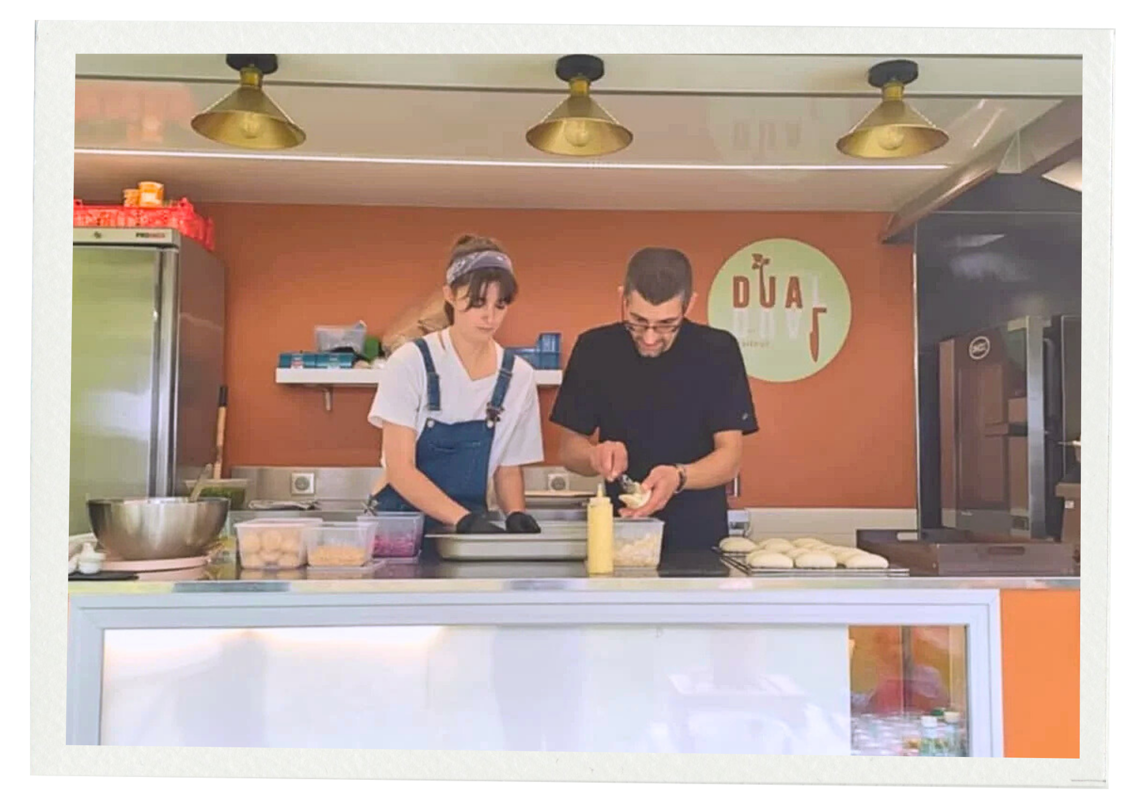 Bertille & Gregory en cuisine en train de préparer des aliments dans le food truck.
