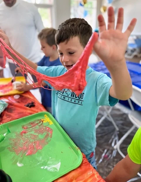 Slime Scientist guest stretching their custom slime at the 67 Slime Co. Mobile Slime Lab Birthday Party.