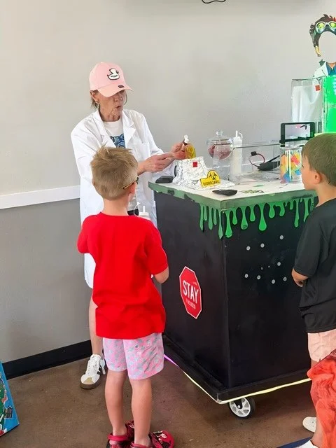 67 Slime Co. Host demonstrating a science experiment with  two 67 Slime Scientists.  They are attending a 67 Slime Co. Mobile Lab Birthday Party.