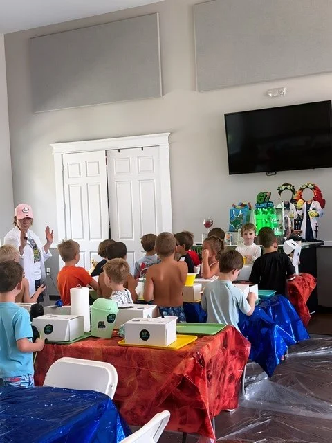 Children gathered around tables with party decorations, as the 67 Slime Co. Host gives instructions, to start the VIP 67 Slime Co. Birthday Party.