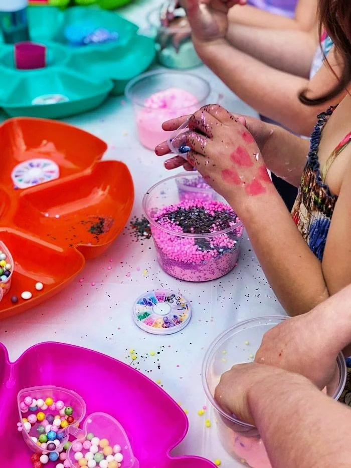 Kids having fun creating custom slime with the 67 SLIME Co Mobile Lab Birthday party.