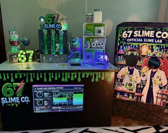 67 Slime mobile lab station with colorful slime containers, slime tools, and a control system screen, decorated with slime-themed graphics and