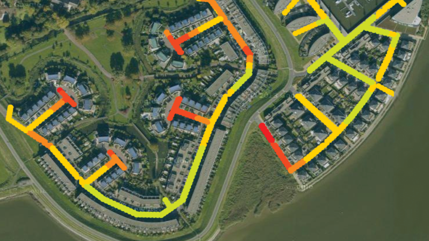 Aerial view of a residential area with colour-coded lines marking a route, indicating varying levels of ground displacement from InSAR time-series data.