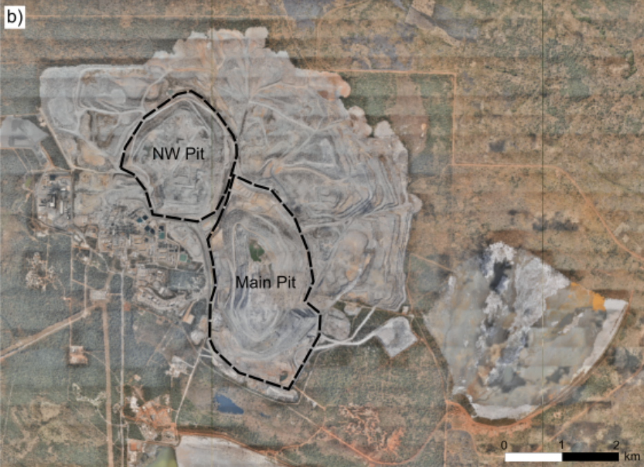 Satellite view of a quarry or mining site with two marked areas labeled NW Pit and Main Pit, showing the excavation zones, roads, and surrounding terrain.